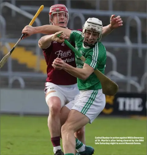  ??  ?? Cathal Dunbar in action against Willie Devereux of St. Martin’s after being cleared by the DRA late Saturday night to assist Naomh Eanna.