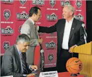  ?? JAMES BARRON/THE NEW MEXICAN ?? UNM athletic director Paul Krebs, right, speaks Tuesday to new Lobos coach Paul Weir, who holds the traditiona­l cherry blazer. Weir declined to put on the jacket, saying he had yet to earn the right to wear it. At left is UNM acting president Chaouki Abdallah.