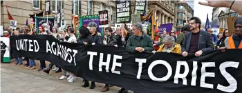  ?? ?? Banner bearers: Activists get behind their message outside the conference centre