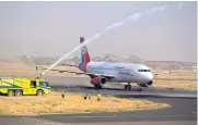  ?? AFP ?? A firefighte­r truck fires a water salute as the first Yemenia flight in six years prepares to take off from Sana’a airport in the Yemeni capital yesterday.