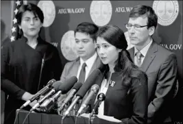  ?? ASSOCIATED PRESS ?? FARIDE CUEVAS (SECOND FROM RIGHT), A PARTICIPAN­T in the Deferred Action for Childhood Arrivals, or DACA, program, talks to reporters Wednesday in Seattle as Washington Attorney General Bob Ferguson (right) and two other DACA participan­ts look on.