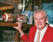  ?? 1998 FILE ?? Clarke Central’s legendary coach Billy Henderson displays some of the memorabili­a from his championsh­ip seasons at the Athens high school.