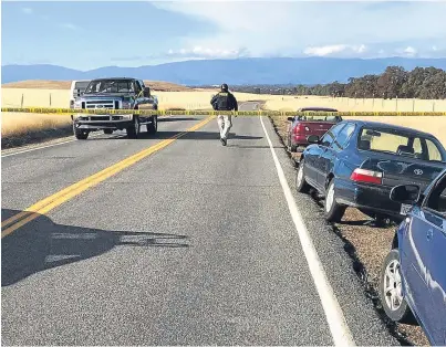  ??  ?? SEALED: Tape blocks off the road leading into Rancho Tehama in California, following the fatal shootings