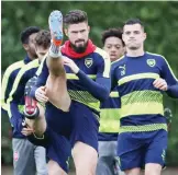  ?? — AP ?? LONDON: Arsenal’s Olivier Giroud stretches during a training session ahead of the Champions League group stage soccer match, in London yesterday. Arsenal plays Paris St Germain in London today.