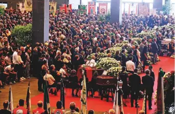  ?? AP ?? People attend a funeral service for some of the victims of a collapsed highway bridge, in Genoa’s exhibition centre Fiera di Genova, Italy, yesterday.