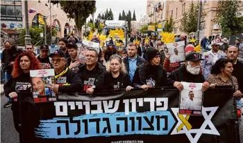  ?? Ohad Zwigenberg/associated Press ?? Relatives and supporters of the Israeli hostages held in the Gaza Strip by the Hamas militant group leads the Purim parade in Jerusalem on Monday.