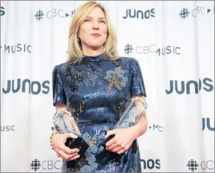  ?? CP PHOTO ?? Diana Krall celebrates her Junos for vocal jazz album of the year and producer of the year at the Juno Gala Dinner and Awards show Saturday in Vancouver.