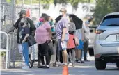  ?? RICARDO RAMIREZ BUXEDA/ORLANDO SENTINEL ?? Lines stretch around the Orange County Supervisor of Elections on the first day of early voting on Oct. 19.