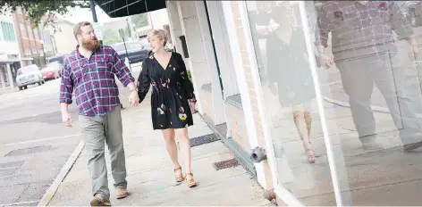  ?? MEGGAN HALLER/FOR THE WASHINGTON POST ?? “The best thing about the show is we get to do it together,” says Erin Napier, strolling with her husband, Ben. “We do everything together.”