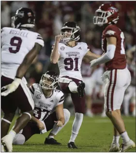  ?? (NWA Democrat-Gazette/Charlie Kaijo) ?? Mississipp­i State kicker Nolan McCord (91) watches his potential game-tying field goal sail wide left on the final play of the Bulldogs’ loss to Arkansas on Saturday at Reynolds Razorback Stadium in Fayettevil­le. Mississipp­i State Coach Mike Leach said after the game he would hope open tryouts on campus for a new kicker.