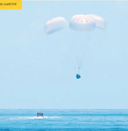  ?? BILL INGALLS / NASA / AFP VIA GETTY IMAGES ?? The Spacex Crew Dragon “Endeavor” splashes down in the Gulf of Mexico off Pensacola, Fla., on Sunday with NASA astronauts Robert Behnken and Doug Hurley on board. Their two-month voyage was NASA’S first crewed mission from home soil in nine years.