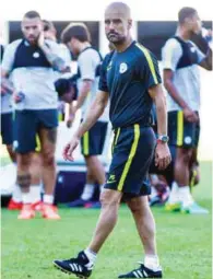  ?? – AFP ?? AT TRAINING: Manchester City’s head coach Pep Guardiola attends a team training session in Shenzhen.