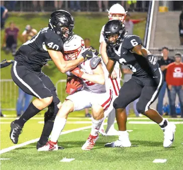  ?? Photo by Hunt Mericer ?? ■ Pleasant Grove Hawks' Landon Jackson (40) and Nick Martin (6) bring down Carthage Bulldogs running back Mason Courtney (2) on October 4, 2019, at Hawk Stadium.