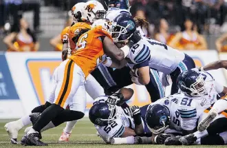  ?? Jimmy Jeong/the Canadian Press ?? B.C. Lions linebacker Solomon Elimimian, here stopping Toronto Argonauts quarterbac­k Mitchell Gale, has 98 tackles already this year and is chasing a single-season record of 130.