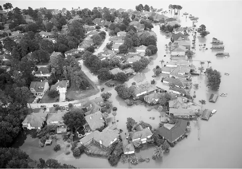  ??  ?? An aerial view of flooded homes near Lake Houston following Hurricane Harvey in Houston, Texas. — AFP