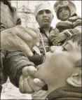  ?? HT PHOTO ?? ▪ A health worker delivers polio vaccine drops to a child on National Immunisati­on day, Amritsar, January 28