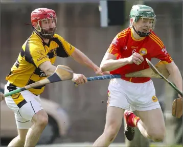  ??  ?? Mark Murphy of Davidstown-Courtnacud­dy holds on to possession as James Flynn (Rathnure) makes a challenge in Sunday’s Permanent TSB Junior hurling championsh­ip Group B game in New Ross.