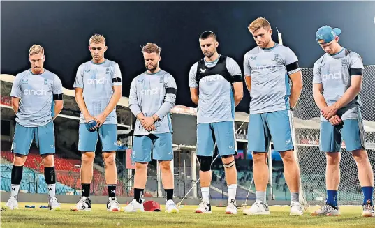  ?? ?? Thinking of home: England players (from left) Luke Wood, Olly Stone, Ben Duckett, Mark Wood, David Willey and Jordan Cox stand for a minute’s silence in memory of Queen Elizabeth II before a net session in Karachi yesterday