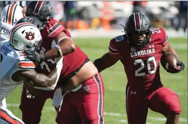  ?? (AP/Sean Rayford) ?? South Carolina running back Kevin Harris (20) eludes the Auburn defense Saturday to score a touchdown during the Gamecocks’ 30-22 victory over the No. 15 Tigers in Columbia, S.C.