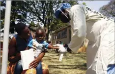  ?? PHOTO/TSVANGIRAY­I ?? A health worker attends to a child su ering from cholera symptoms at a local hospital in Harare on Tuesday. A cholera emergency has been declared in Zimbabwe’s capital after 20 people have died, the health minister said Tuesday. AP