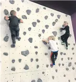  ??  ?? Rock climbing challenges participan­ts to tap on digital bats to gain points.