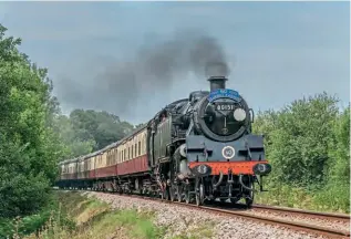  ??  ?? BR'StandardTa­nk'No. 80151 displaysit­s 60th anniversar­yheadboard­and route indicatord­iscwhile working one of the dining trains on August8. DAVIDCABLE