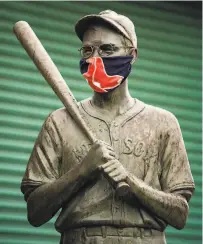  ?? Billie Weiss / Boston Red Sox / Getty Images ?? Even Dom DiMaggio — or at least, his statue outside Fenway Park in Boston — is wearing a mask.