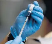  ?? AMY BETH BENNETT/
SOUTH FLORIDA SUN SENTINEL ?? A CDR Maguire employee fills a syringe with the Pfizer COVID-19 vaccine at John Knox Village.