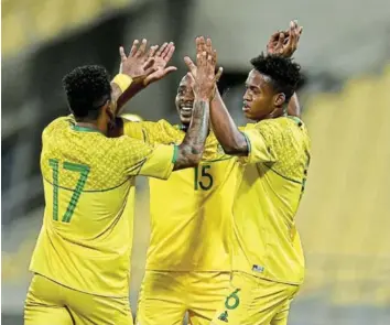  ?? Picture: GALLO IMAGES/LEFTY SHIVAMBU ?? FIRST BLOOD: SA ’ s Luther Singh celebrates his goal with Thabo Nodada and Kermit Erasmus during the Internatio­nal friendly match against Namibia at Royal Bafokeng Stadium in Rustenburg. The final score was 1-1.