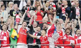  ?? THE ASSOCIATED PRESS ?? Arsenal players celebrate with the trophy after winning the English FA Cup final soccer match against Chelsea 2-1 at London’s Wembley Stadium on Saturday.