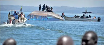  ?? AP PHOTO ?? DEADLY DISASTER: Rescue divers stand on top of the capsized MV Nyerere passenger ferry yesterday on Ukara Island, Tanzania. The death toll soared past 200 while a survivor was found inside the capsized ferry and search efforts were being wrapped up to focus on identifyin­g bodies.
