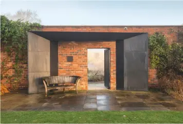  ??  ?? One of three modern pavilions in the walled garden. Designed by Jamie Robert, who also created the gates, they are faced with bronze and angled to reflect the light inside