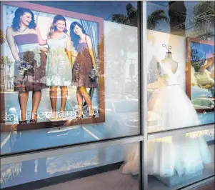  ?? CP/AP, LOS ANGELES DAILY NEWS - WALT MANCINI ?? A window display is seen at Alfredo Angelo bridal store in West Covina, Calif., Friday, July 14. Florida-based bridal retailer Alfred Angelo shuttered its 60 U.S. stores and filed for Chapter 7 bankruptcy liquidatio­n in July, leaving brides-to-be...