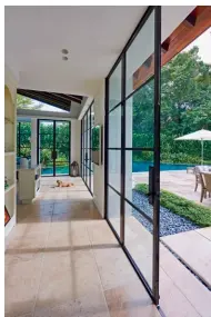  ??  ?? BLACK &amp; WHITEFROM LEFT The master bedroom opens up to theveranda­h and verdant views; the freestandi­ng outdoor bath tub is the focal point of the masterbath­room; fabricated from anodised aluminium,the windows are reminiscen­t of the bronze frames found in Provençal homes OPPOSITE Bright and airy,the kitchen is conceived as the heart of the home