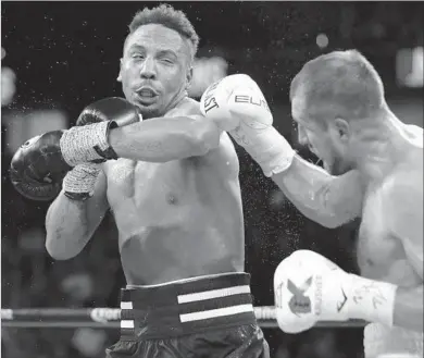  ?? Al Bello Getty Images ?? ANDRE WARD, left, hits Sergey Kovalev during a light-heavyweigh­t bout in Las Vegas last November, when Ward won by unanimous decision. Kovalev will get a chance for payback June 17, again in Vegas.