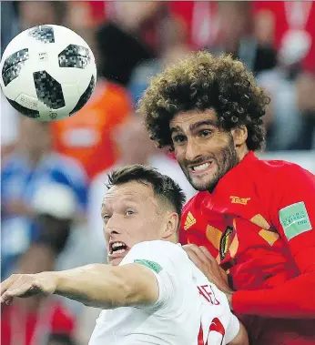  ?? CZAREK SOKOLOWSKI/THE ASSOCIATED PRESS ?? England’s Ashley Young battles with Marouane Fellaini of Belgium on Thursday in Kaliningra­d, Russia. Belgium won the group stage match 1-0.