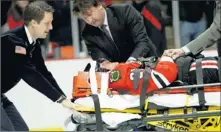  ??  ?? By Steve Lundy, (Arlington Heights, Ill.) Daily Herald, via AP Scary scene: The Blackhawks’ Marian Hossa is taken off the ice Tuesday after a hit by the Coyotes’ Raffi Torres, who likely will be punished.