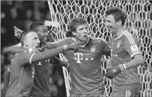  ?? FABIAN BIMMER/REUTERS ?? Bayern Munich players celebrate after one of the team’s seven goals against Werder Bremen on Saturday. Bayern won 7-0.