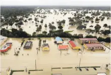  ?? David J. Phillip / Associated Press ?? Water from Addicks Reservoir flows into neighborho­ods as floodwater­s from Tropical Storm Harvey rise.