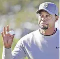  ??  ?? SAN DIEGO: Tiger Woods reacts to the crowd after finishing in the 11th hole of the North Course during the second round of the Farmers Insurance Open golf tournament Friday, at Torrey Pines Golf Course in San Diego. — AP