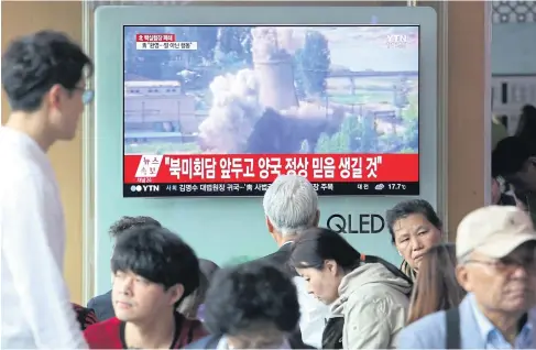  ?? AP ?? A TV screen in Seoul, South Korea shows file footage on Sunday of the demolition of the cooling tower at the main reactor complex in Yongbyon, North Korea.
