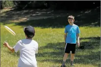  ?? LUIS SÁNCHEZ SATURNO/THE NEW MEXICAN ?? Theo Graeser, 10, left, and Aiden Brandfonbr­ener, 12, play Frisbee at Patrick Smith Park last month during Rio Grande School summer camp.