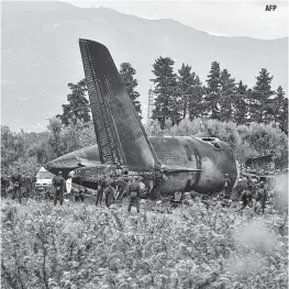  ??  ?? AFP Rescuers are seen around the wreckage of an Algerian army plane which crashed near the Boufarik airbase from where the plane had taken off on Wednesday.The Algerian military plane crashed and caught fire killing 257 people, mostly army personnel and members of their families, officials said.