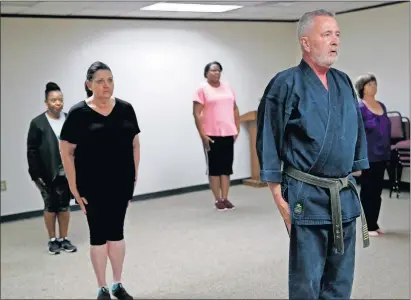  ??  ?? Terry Smith, a constructi­on project manager at the Office of Juvenile Affairs, is a black belt who teaches a weekly self-defense class for his co-workers. [SARAH PHIPPS/ THE OKLAHOMAN]