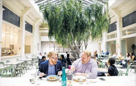  ?? Photograph­s by Jay L. Clendenin Los Angeles Times ?? DAVE LOFSTROM, left, and Nicolas Somers laugh over lunch at Spring, chef Tony Esnault’s new restaurant in downtown L.A.