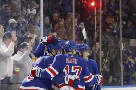  ?? KATHY WILLENS - THE ASSOCIATED PRESS ?? Teammates celebrate with New York Rangers left wing Chris Kreider, left, after Kreider scored a goal during the second period of a game against the Anaheim Ducks, Sunday, Dec 22, 2019, in New York. It was Kreider’s second goal of the game.