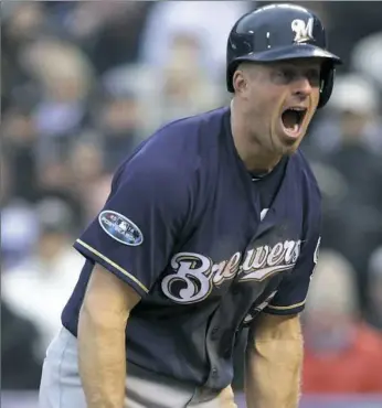  ?? Joe Mahoney/Associated Press ?? Milwaukee Brewers catcher Erik Kratz celebrates after scoring Sunday in Game 3 against the Colorado Rockies. The Brewers won, 6-0, to sweep the National League Division Series.