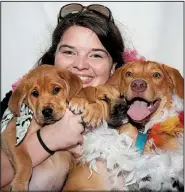  ?? Arkansas Democrat-Gazette/CARY JENKINS ?? Rock City Rescue volunteer Melody Allenswort­h-James, who is usually behind the camera, poses in a photo-booth with three dogs she is fostering: Wolverine, Ironman and Bloomy.