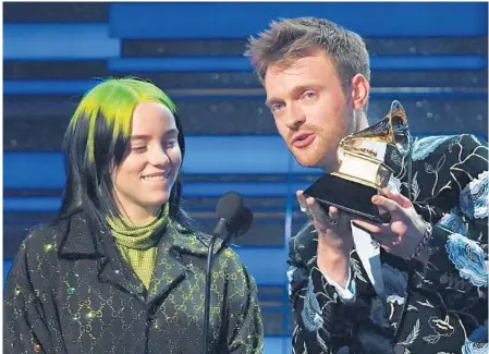  ?? ROBYN BECK/GETTY-AFP ?? Billie Eilish and her brother Finneas accept the song of the year award for “Bad Guy” during the Grammy Awards Sunday.