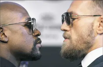  ?? John Locher/Associated Press ?? Floyd Mayweather Jr., left, and Conor McGregor pose for photograph­ers at a news conference Wednesday in Las Vegas. The two fought late Saturday night in Las Vegas.